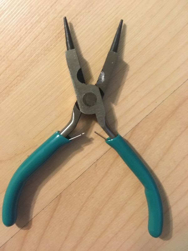 A round-nose plier, flat-nose plier, and wire cutter 3-in-1